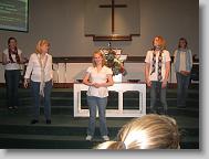 The high school sign language team is preparing to practice signing for the worship service on Sunday.